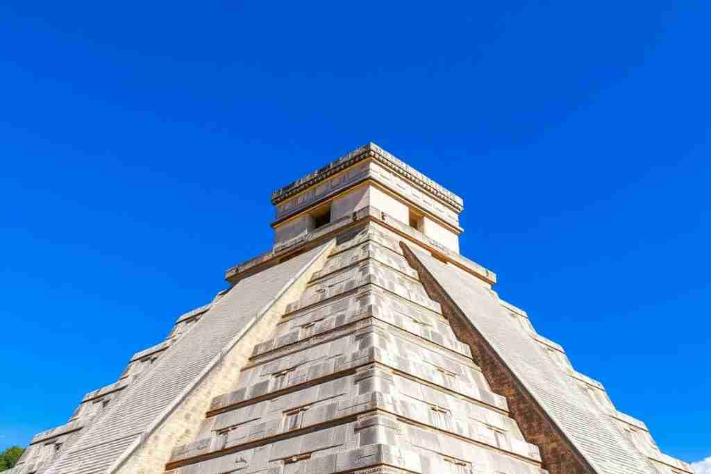 El Castillo (Pyramid of Kukulcan) at Chichen Itza with perfect blue sky background El Castillo (Pyramid of Kukulcan) at Chichen Itza with perfect blue sky background